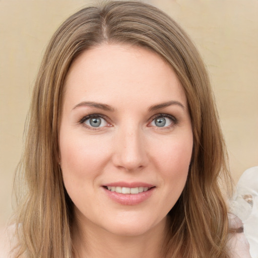 Joyful white young-adult female with long  brown hair and green eyes