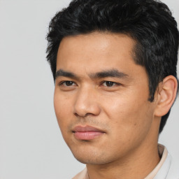 Joyful asian young-adult male with short  black hair and brown eyes