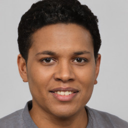 Joyful latino young-adult male with short  brown hair and brown eyes