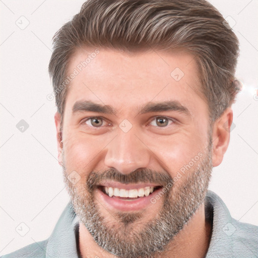 Joyful white adult male with short  brown hair and brown eyes