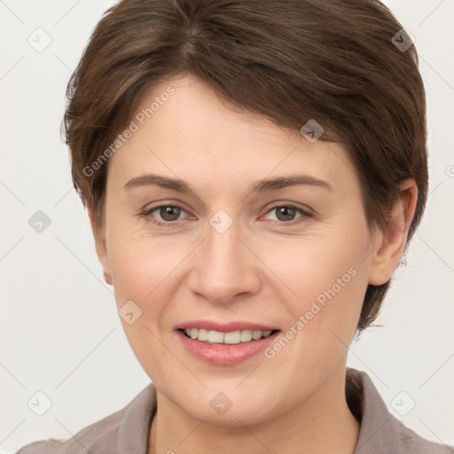 Joyful white young-adult female with short  brown hair and grey eyes