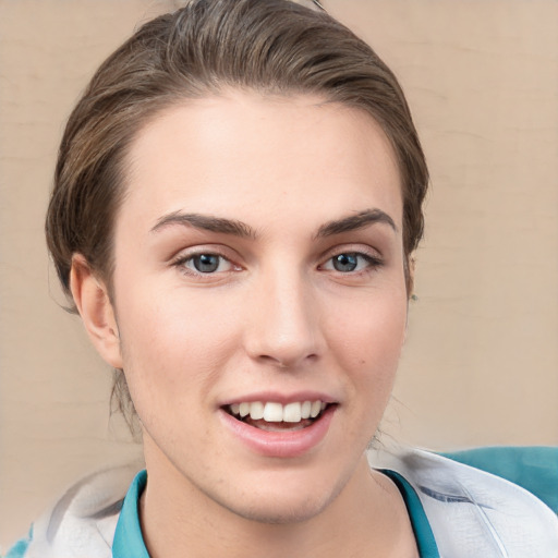 Joyful white young-adult female with short  brown hair and grey eyes