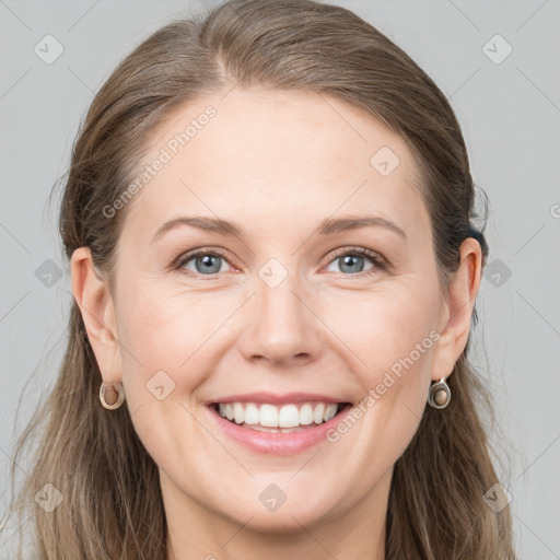 Joyful white young-adult female with long  brown hair and grey eyes