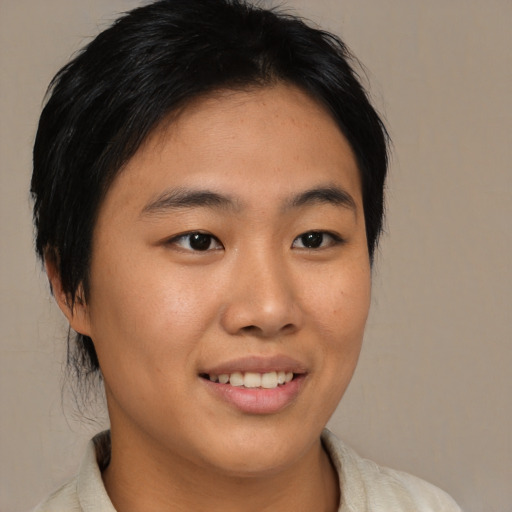 Joyful asian young-adult female with medium  black hair and brown eyes