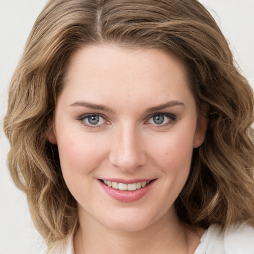 Joyful white young-adult female with medium  brown hair and green eyes