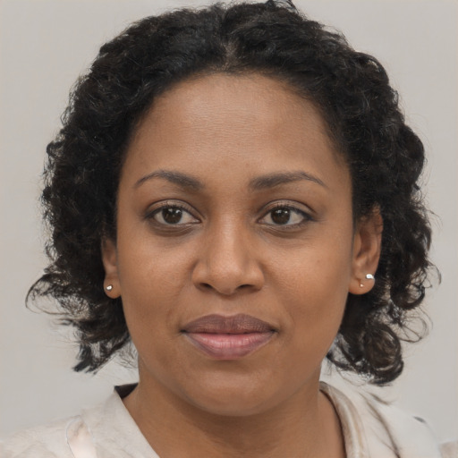 Joyful black adult female with medium  brown hair and brown eyes