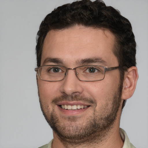 Joyful white adult male with short  brown hair and brown eyes