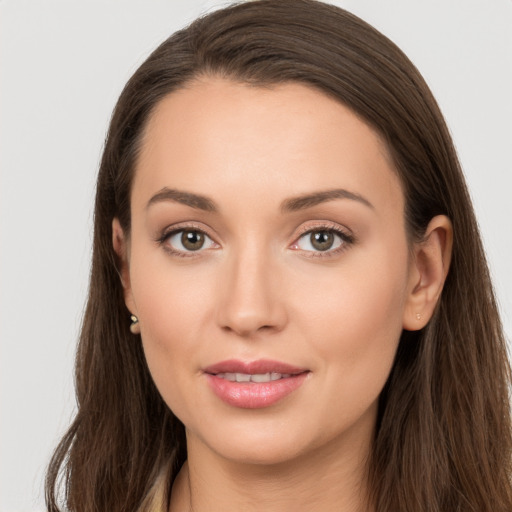 Joyful white young-adult female with long  brown hair and grey eyes