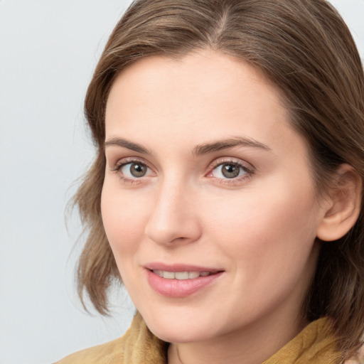 Joyful white young-adult female with medium  brown hair and blue eyes