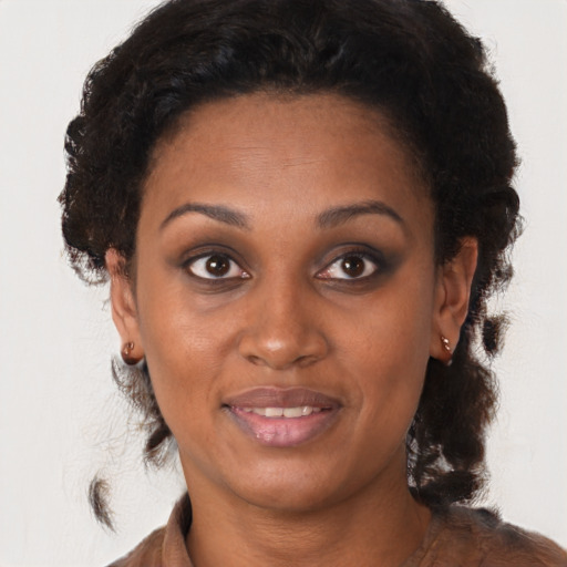 Joyful black young-adult female with medium  brown hair and brown eyes