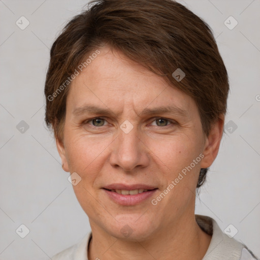 Joyful white adult female with short  brown hair and grey eyes