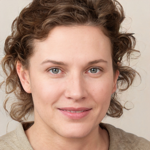 Joyful white young-adult female with medium  brown hair and blue eyes