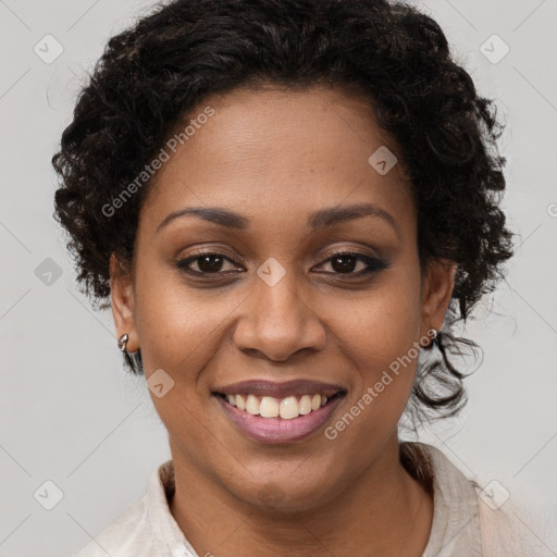 Joyful black adult female with medium  brown hair and brown eyes