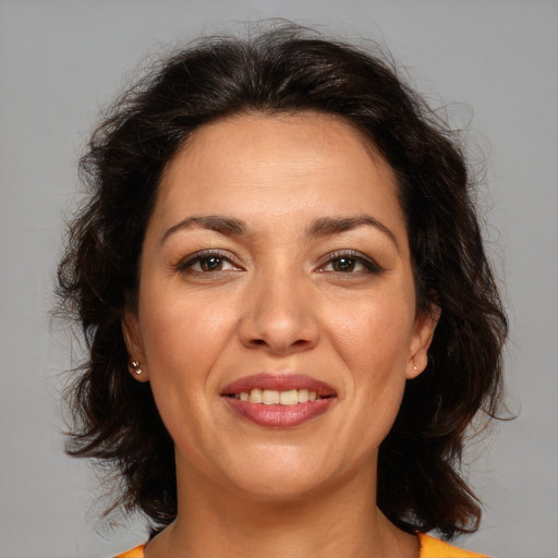 Joyful white adult female with medium  brown hair and brown eyes