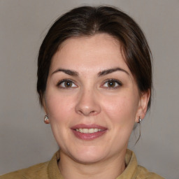 Joyful white young-adult female with medium  brown hair and brown eyes