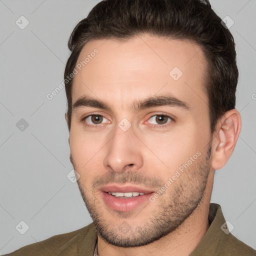 Joyful white young-adult male with short  brown hair and brown eyes