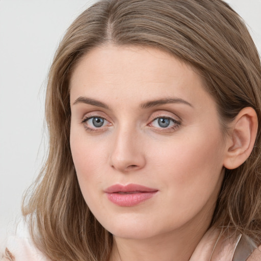 Joyful white young-adult female with long  brown hair and blue eyes