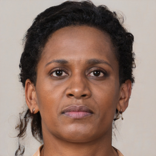 Neutral black young-adult female with medium  brown hair and brown eyes