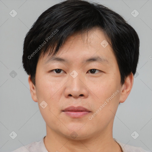 Joyful asian young-adult male with short  brown hair and brown eyes