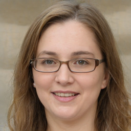 Joyful white young-adult female with long  brown hair and green eyes