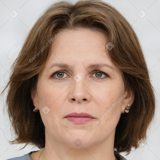 Joyful white adult female with medium  brown hair and grey eyes