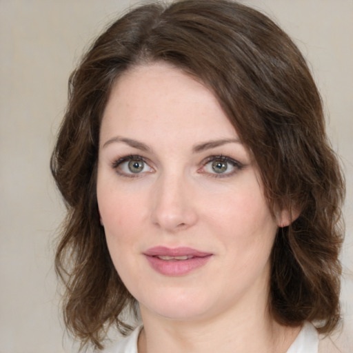 Joyful white young-adult female with medium  brown hair and green eyes