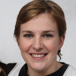 Joyful white young-adult female with medium  brown hair and grey eyes