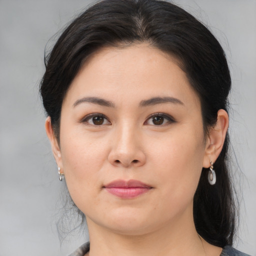 Joyful asian young-adult female with medium  brown hair and brown eyes