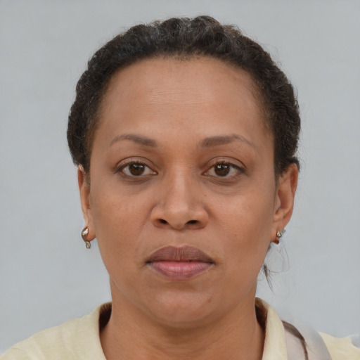 Joyful black adult female with short  brown hair and brown eyes