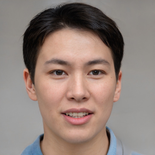 Joyful asian young-adult male with short  brown hair and brown eyes