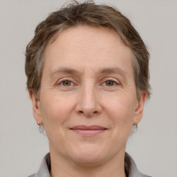 Joyful white adult female with short  brown hair and grey eyes