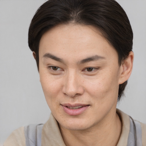Joyful asian young-adult female with short  brown hair and brown eyes