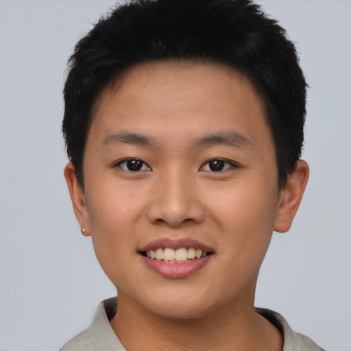 Joyful asian young-adult male with short  black hair and brown eyes