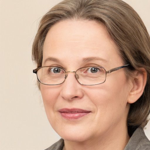 Joyful white adult female with medium  brown hair and blue eyes