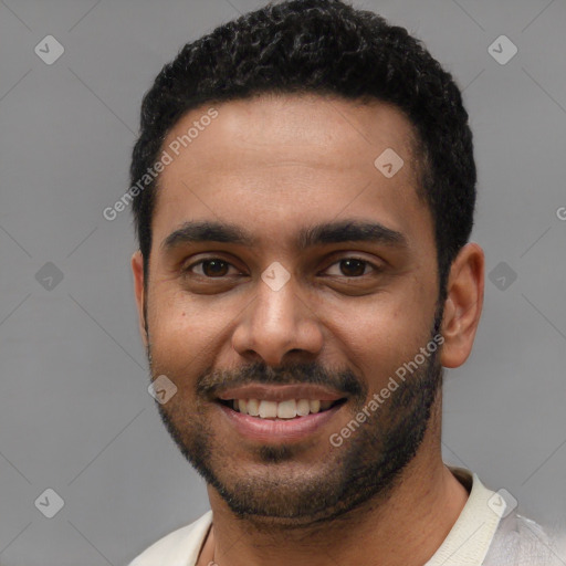 Joyful black young-adult male with short  black hair and brown eyes