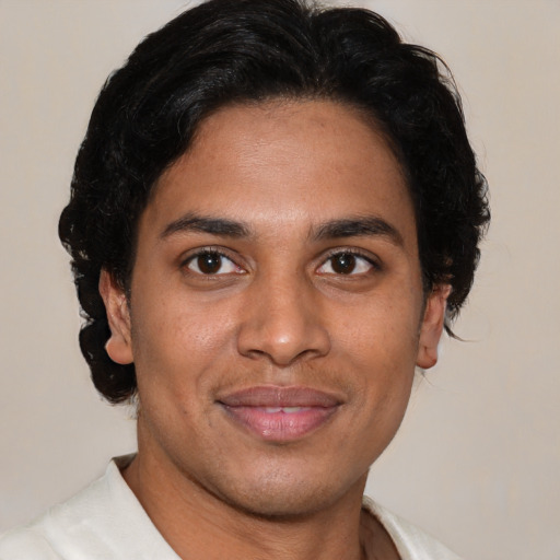 Joyful latino young-adult male with short  brown hair and brown eyes