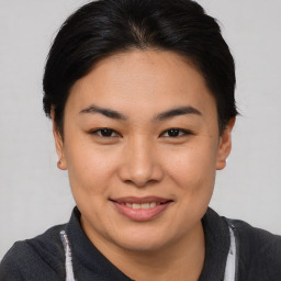 Joyful asian young-adult female with short  brown hair and brown eyes