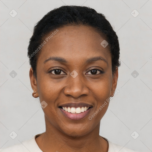 Joyful black young-adult female with short  black hair and brown eyes