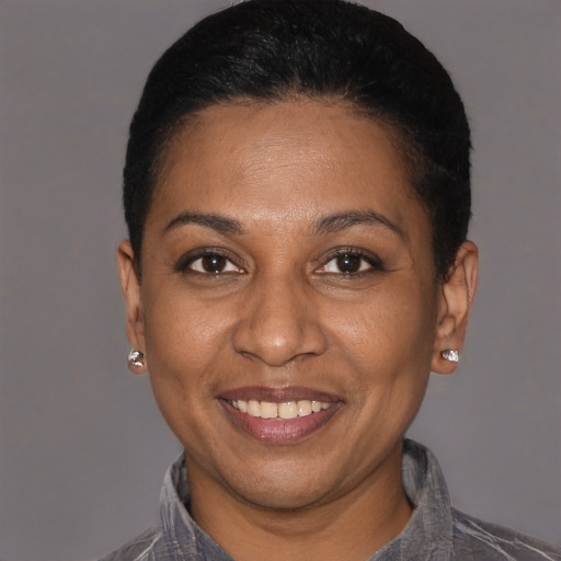 Joyful black adult female with short  black hair and brown eyes