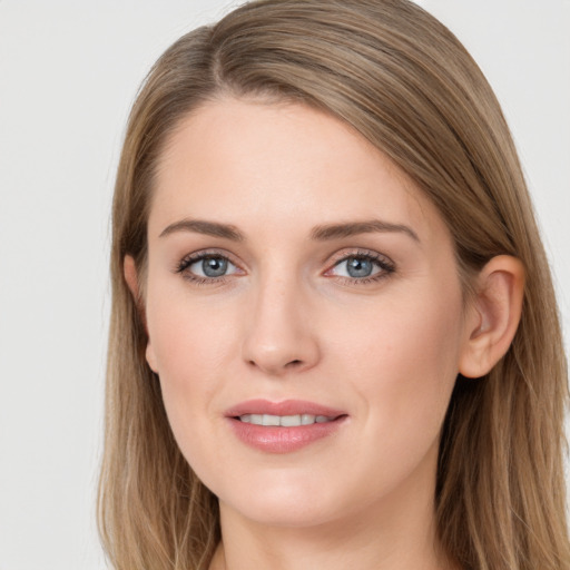 Joyful white young-adult female with long  brown hair and grey eyes