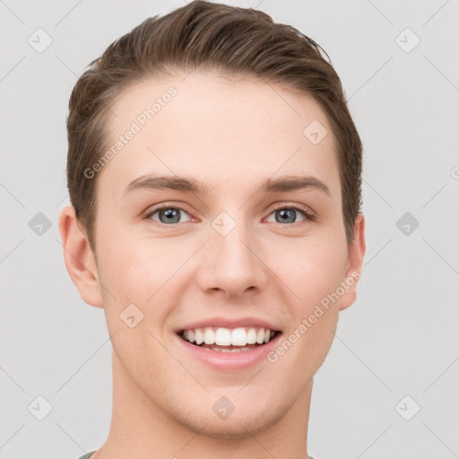 Joyful white young-adult male with short  brown hair and grey eyes