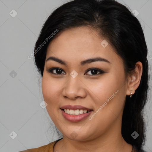 Joyful latino young-adult female with long  brown hair and brown eyes