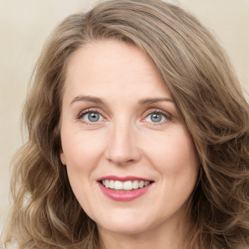 Joyful white young-adult female with medium  brown hair and green eyes