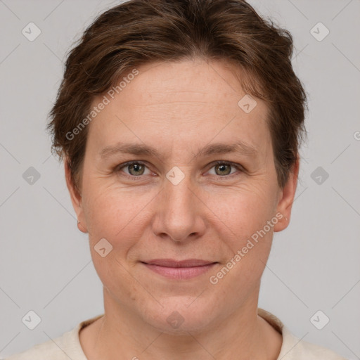 Joyful white adult female with short  brown hair and grey eyes