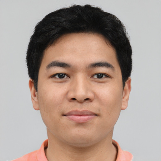 Joyful asian young-adult male with short  black hair and brown eyes