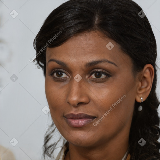 Joyful black young-adult female with long  brown hair and brown eyes