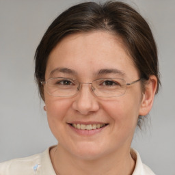 Joyful white adult female with medium  brown hair and brown eyes