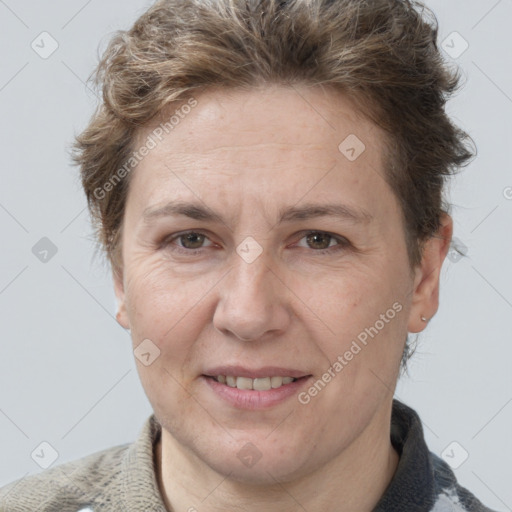 Joyful white adult female with short  brown hair and grey eyes