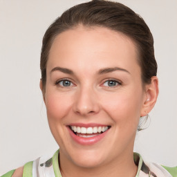 Joyful white young-adult female with medium  brown hair and green eyes