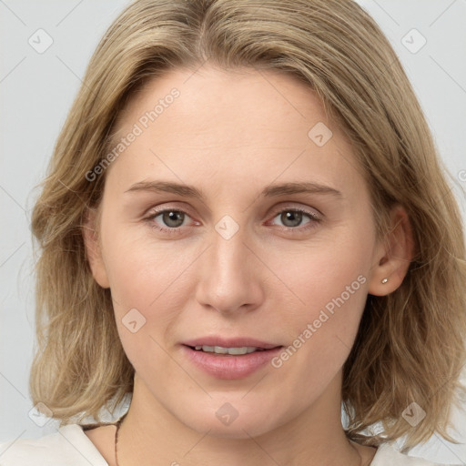 Joyful white young-adult female with medium  brown hair and blue eyes